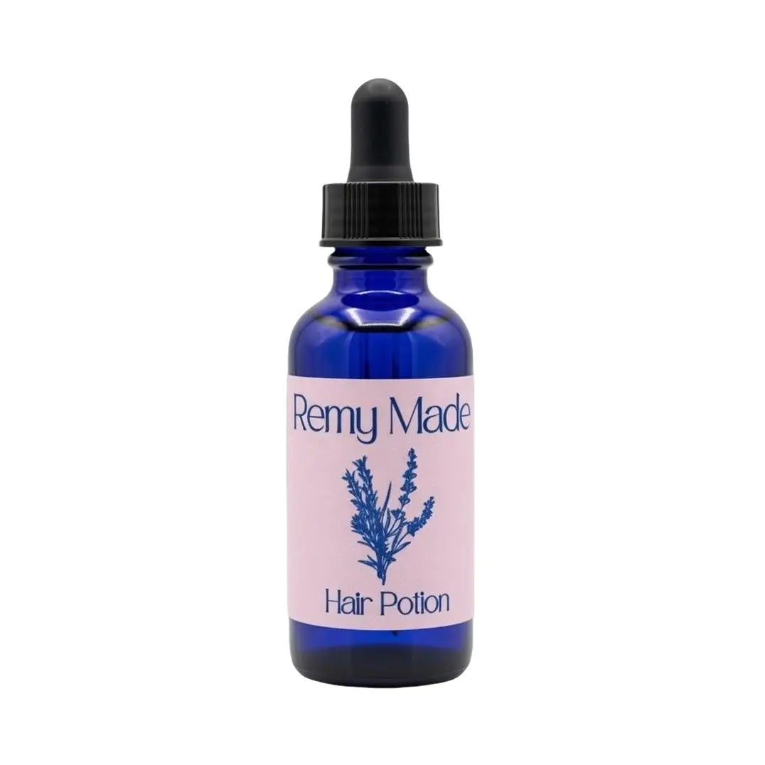 Remy Made Hair Potion botanical hair oil in blue glass dropper bottle