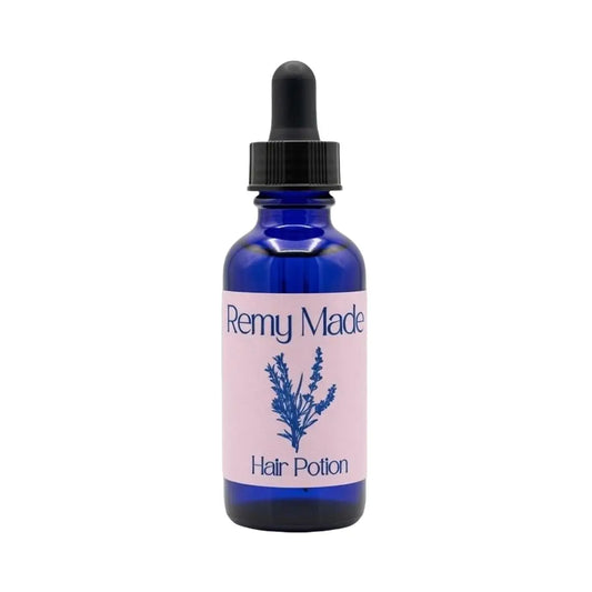 Remy Made Hair Potion botanical hair oil in blue glass dropper bottle